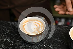 Cup of fresh aromatic coffee on table