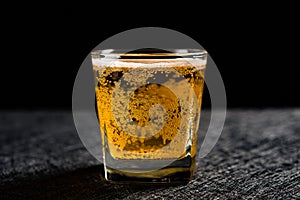 Cup of fresh beer on dark background