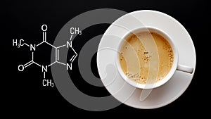 Cup of fresh coffee on a black background. Blackboard with the chemical formula of caffeine. Top view with copy space