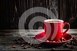 Cup of fresh coffee with coffee beans on wooden table