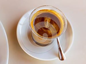 Cup of fresh cortado on table photo