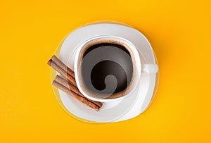 Cup of fresh espresso on yellow background, view from above