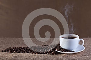 Cup of hot steaming coffee photo