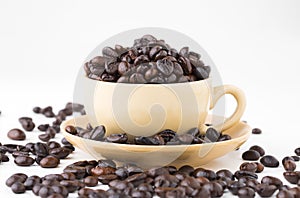 Cup full of coffee beans on on white background