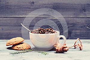 Cup full coffee brown roasted bean blue wooden background. Caffeine concept. Cafe drinks menu. Arabica robusta coffee