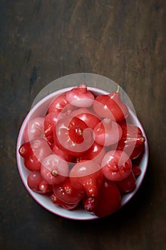 cup full of jambu or rose apple on table top