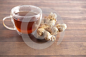Cup of Ginger Root Tea on a Wooden Table