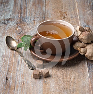 Cup of ginger tea, cubes of brown sugar