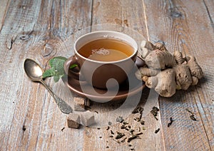 Cup of ginger tea, cubes of brown sugar photo