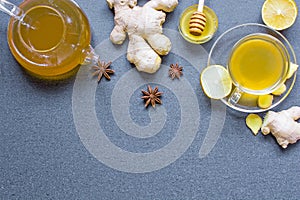 Cup of ginger tea and teapot with lemon, honey and spices