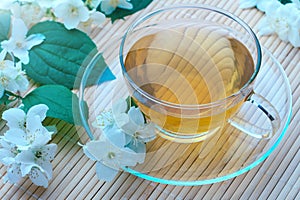 cup of green tea with jasmine flowers