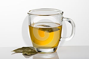 Cup of green tea with leaves