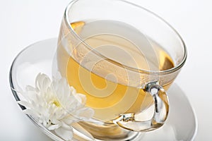 Cup of green tea and white flower