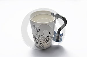 A cup with guitar handle. A cup for musician. Cup ispolated on white background.Copy space photo