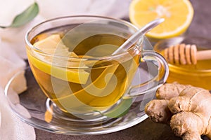 A cup of healthy tea with ginger, honey and lemon. Close-up