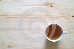 Cup of Herb Tea on Wooden Table in Morning Light, Top View with Free Space for Text