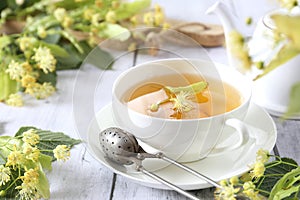 Cup of herbal linden tea with linden flowers