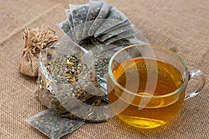 Cup of herbal tea and herbal tea bags, concept of natural treatment