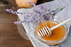 Cup of herbal tea with sage and honey with spoon in glass bowl o