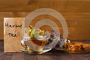 Cup of herbal tea with wild flowers and various herbs