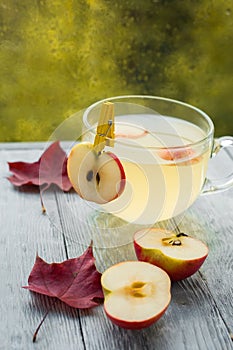 Cup of hot Apple punch in rainy autumn weather. Drink on the wooden table by the window