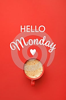 Cup of hot aromatic coffee and phrase Hello Monday on red background, top view