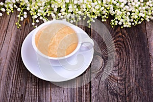 Cup of hot black coffee on a gray wooden surface