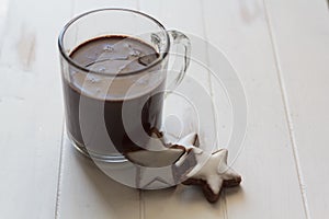 Cup of hot chocolate and cookies on white wooden table