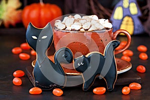 Cup  with  hot chocolate drink and gingerbread cookies  for  Halloween holiday