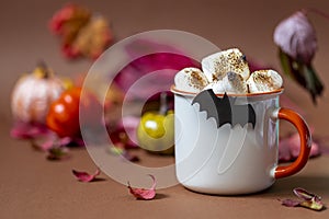 Cup of hot chocolate with marshmallow. Tasty Halloween food. Concept of cozy winter home environment. Autumn background.