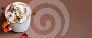 Cup of hot chocolate with marshmallow. Tasty Halloween food. Concept of cozy winter home environment. Autumn background.