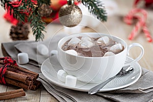 Cup of hot chocolate with marshmallows and holiday decorations
