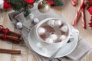 Cup of hot chocolate with marshmallows and holiday decorations