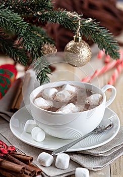 Cup of hot chocolate with marshmallows and holiday decorations