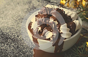 Cup of hot chocolate with marshmallows on snowy table, Christmas, New Year, Winter background