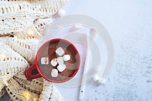 A cup hot chocolate whit marshmallow,  and knitting wool sweater, copy space for merry Christmas and happy new year concept