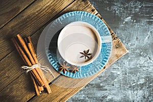 Cup of hot chocolate in winter decorations on the rustic background