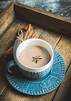 Cup of hot chocolate in winter decorations on the rustic background