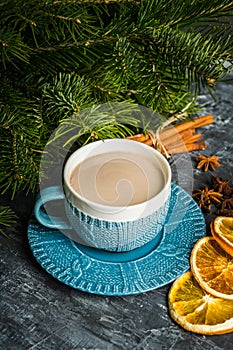 Cup of hot chocolate in winter decorations on the rustic background