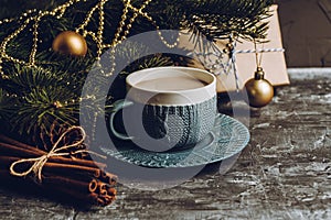 Cup of hot chocolate in winter decorations on the rustic background