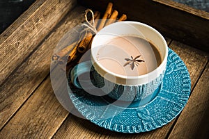 Cup of hot chocolate in winter decorations on the rustic background