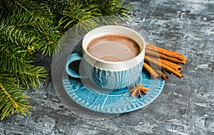 Cup of hot chocolate in winter decorations on the rustic background