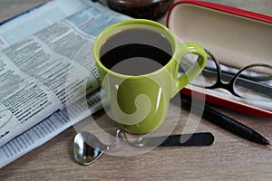 Cup of hot coffee on a good day and a morning newspaper