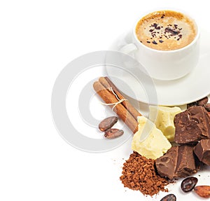 Cup of hot coffee and ingredients for making chocolate