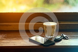 Cup of hot coffee , Key of car and smartphone in cafe.The concept of drinking coffee for leisure, travel and modern lifestyle