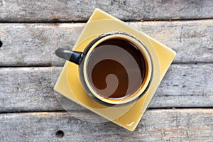 Cup of hot coffee on an old wooden table