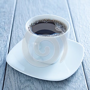 Cup of hot coffee on saucer