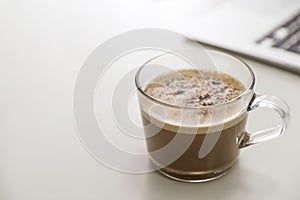 Cup of hot coffee on white table indoors. Space for text