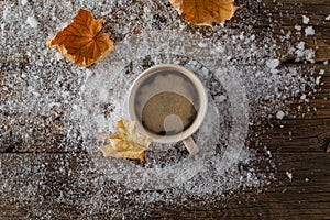 Cup with hot drink over winter forest background