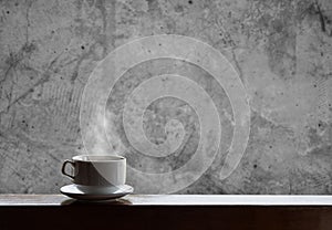 Cup of hot drinks with steam on wood table and concrete background, hot coffee, tea, chocolate and etc.